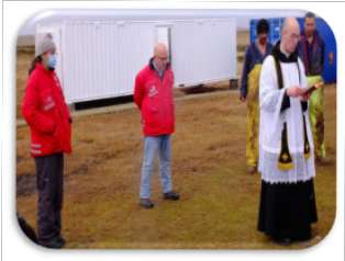 A priest blesses the work of the International Red Cross in the Falkland Islands