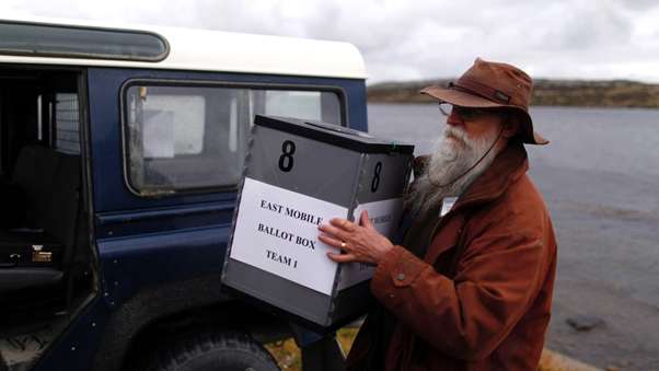 Phil Middleton of Stanley loads ballot boxes for East Falkland.